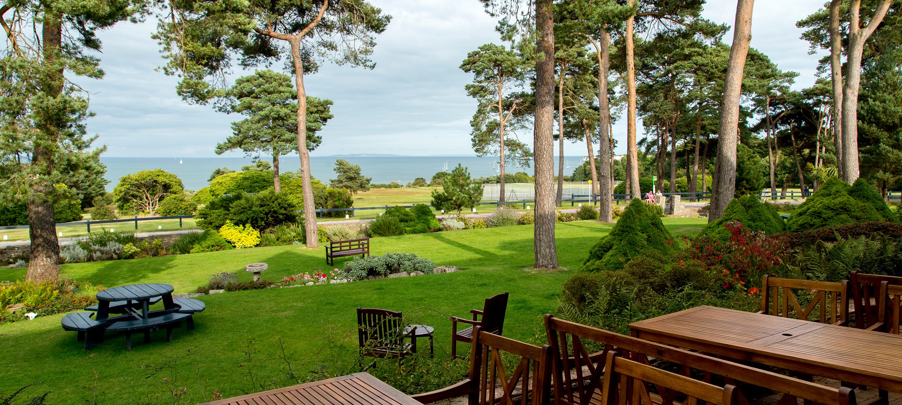 Trees and gardens overlooking the bay at a Dorset beach hotel